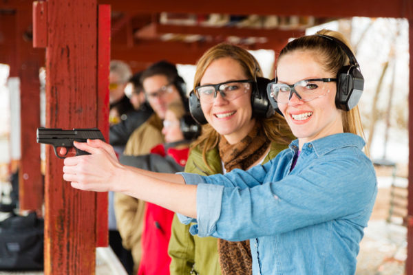 A group of people practicing at the gun range. Photographed on location at a shooting range.